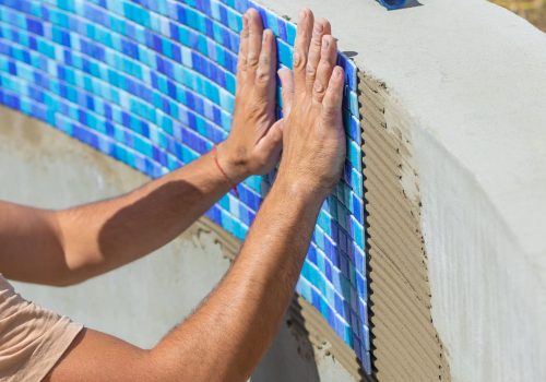 a-man-lays-mosaic-tiles-in-a-swimming-pool-select-2026-01-09-13-12-52-utc (1)